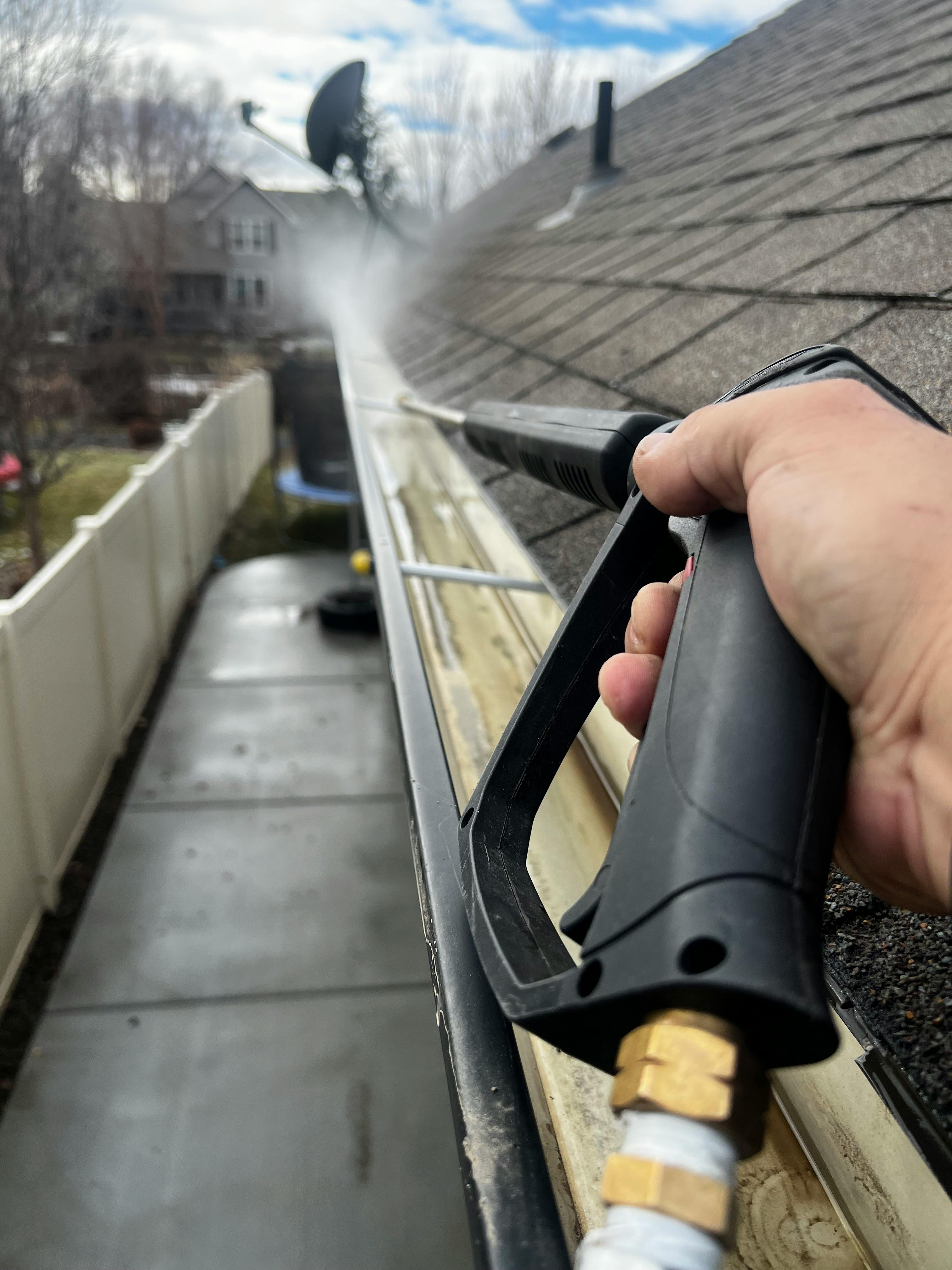 Pressure washer spray cleaning an outdoor surface